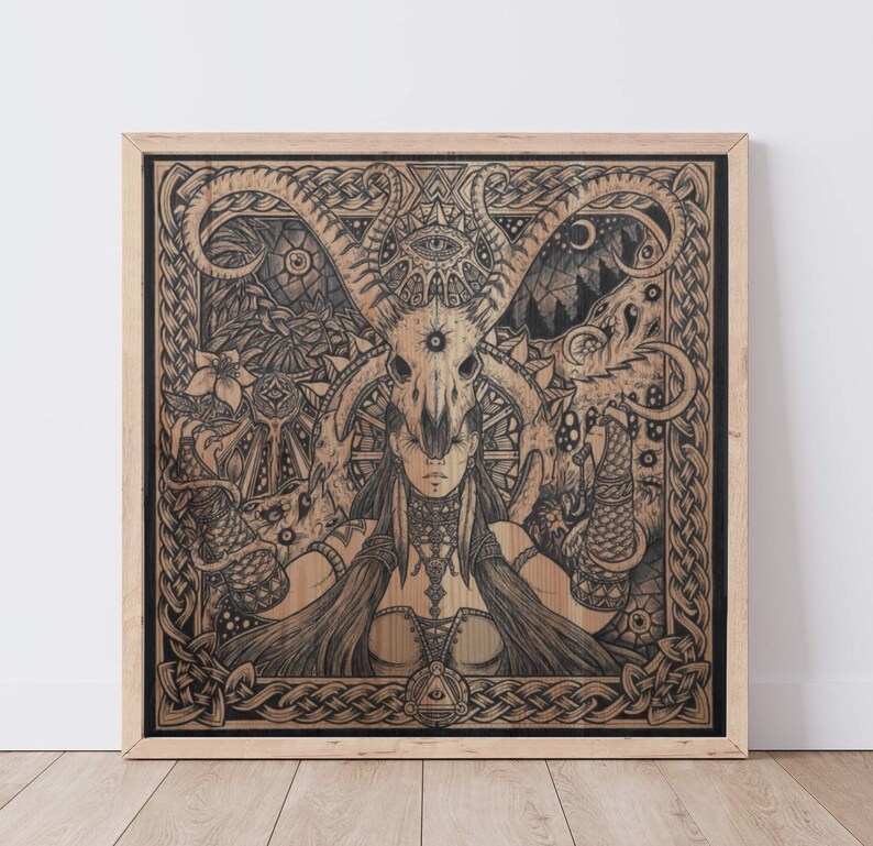 May include: A black and white illustration of a woman with a skull mask and horns. The woman is surrounded by intricate Celtic knotwork and other symbols. The artwork is framed in a light wood frame.