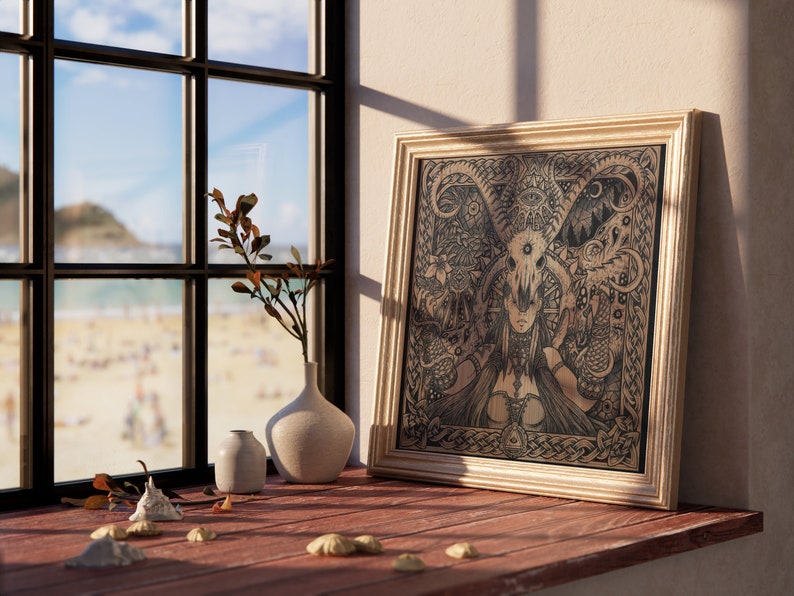 May include: A framed black and white illustration of a woman with a skull head and horns. The illustration is surrounded by a Celtic knot border and features intricate details. The frame is gold and has a wooden finish.