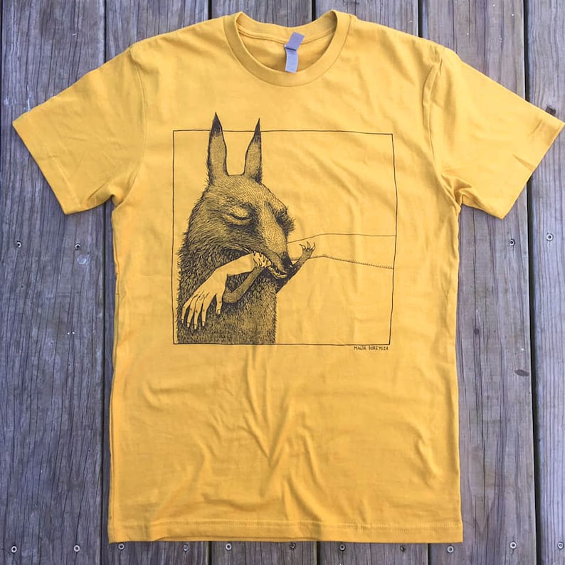 May include: A yellow t-shirt with a black and white illustration of a creature with large ears biting a human arm. The text "PAUL DRESDEN" is printed below the illustration.