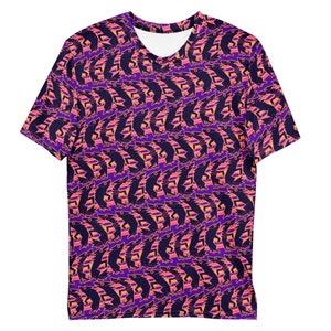 May include: A short-sleeved t-shirt with a repeating pattern of stylized fish in shades of purple, navy, and orange. The shirt has a white neckline and is made of a soft, lightweight material.
