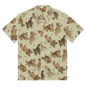 May include: Short-sleeved button-down shirt featuring a repeating pattern of cartoon dogs in different poses. The dogs are brown and tan on a light green background, with paw prints. The shirt has a classic collar and button closure.