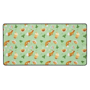 May include: A rectangular desk mat with a repeating pattern of foxes, boba tea, teacups, and butterflies on a light green background. The mat has a black border.