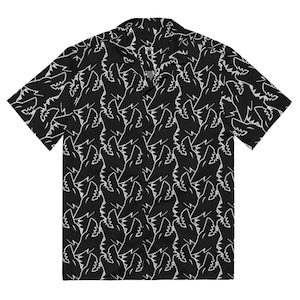 May include: Black short-sleeved shirt featuring a repeating white shark teeth pattern. The shirt has a classic collar and a relaxed fit. The shark teeth design is repeated across the entire shirt, creating a bold and eye-catching look.