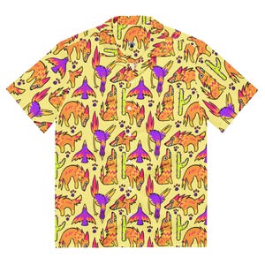 May include: Yellow button-up shirt with a repeating pattern of orange and purple cartoon animals, birds, and cacti. The short-sleeved shirt has a classic collar and is made of a lightweight fabric.