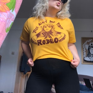 This Ain&#39;t My First Rodeo tshirt, tee, unisex, screenprinted, western, cowgirl, cowboy, 70s cowgirl, 1970s rodeo, line dancing, 60s tassel