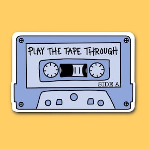 May include: A blue and white cassette tape sticker with the text "PLAY THE TAPE THROUGH" and "SIDE A".