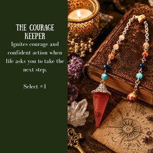 May include: A pendulum featuring a pointed red crystal pendant attached to a silver-toned metal chain with multicolored beads. The text on the left reads: THE COURAGE KEEPER, Ignites courage and confident action when life asks you to take the next step. Select #1.
