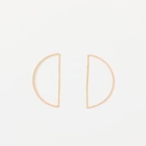 May include: A pair of gold-toned earrings shaped like half circles.