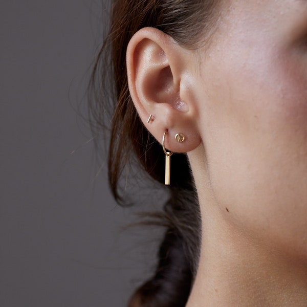 A Pair of Tiny 8kt Golden Waterproof Hoops  with a bar, line, Small Earrings Golden Gold  Earrings bangle