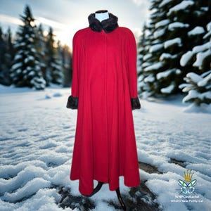 May include: A long, red coat with a black faux fur collar and cuffs. The coat is displayed on a mannequin in a snowy outdoor setting, with evergreen trees in the background. The coat has a classic, elegant design.