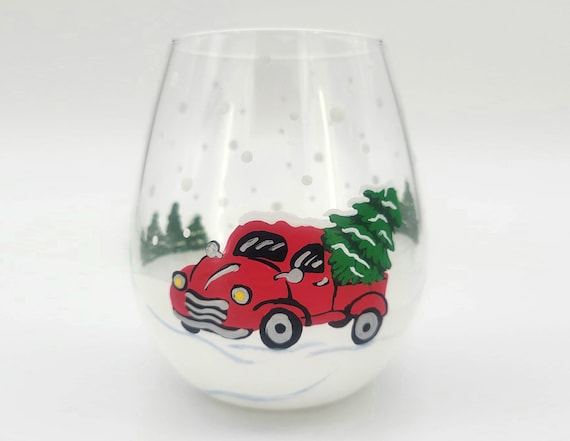 Bringing Home the Christmas Tree Hand Painted Stemless Wine Glass - Red Truck, Pine Tree, Snow