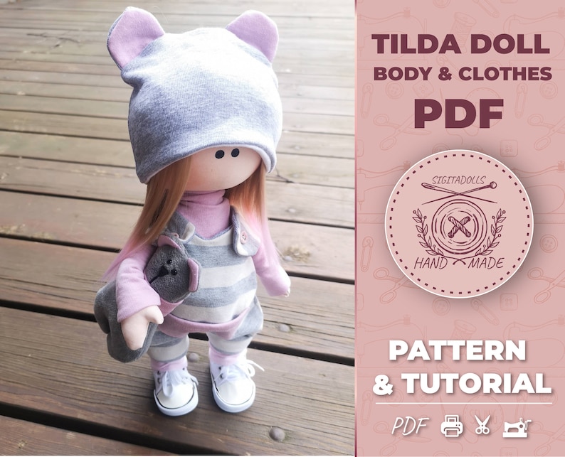 May include: A gray and pink Tilda doll with a gray hat and a striped dress. The doll is holding a gray stuffed animal. The image includes the text "Tilda Doll Body & Clothes PDF Pattern & Tutorial PDF"