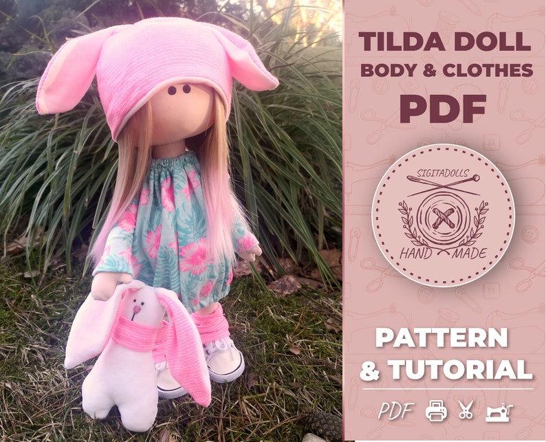 May include: A pink Tilda doll with pink bunny ears and a floral dress, holding a white bunny with pink ears. The image includes the text "Tilda Doll Body & Clothes PDF Pattern & Tutorial PDF"