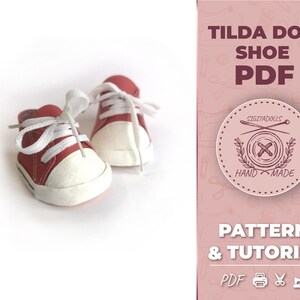 May include: A pair of red canvas shoes with white laces and white soles. The shoes are for a Tilda doll and are part of a PDF pattern and tutorial. The text on the image reads "Tilda Doll Shoe PDF, Sigitadolls Hand Made, Pattern & Tutorial, PDF"