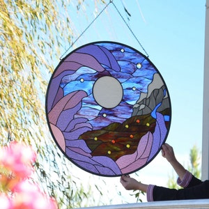 round large hanging stained glass panel of moon, mountains, orchid