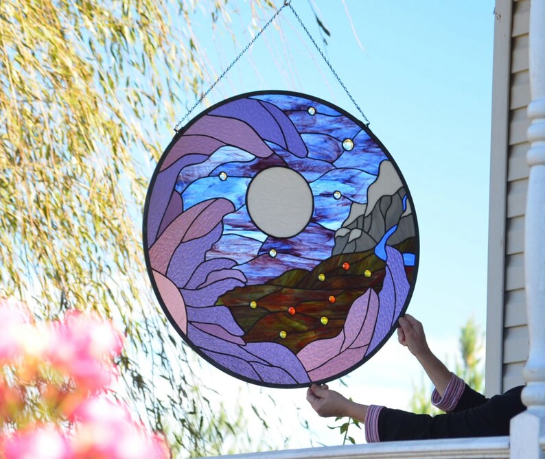 round large hanging stained glass panel of moon, mountains, orchid