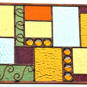stained glass wall art with copper wire accents, frame, and solder coloring