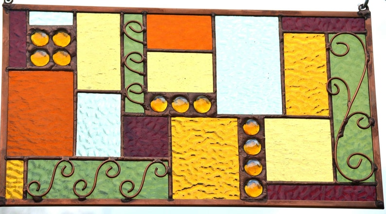 stained glass wall art with copper wire accents, frame, and solder coloring