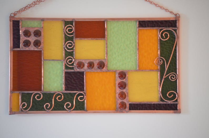 closeup showing copper accents, frame and solder in handmade stained glass panel