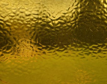 May include: A textured gold surface with a pattern of small, raised bumps.