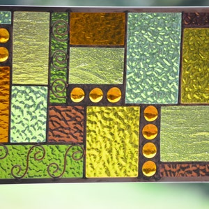 view of textures and colored glass nuggets in handmade stained glass panel