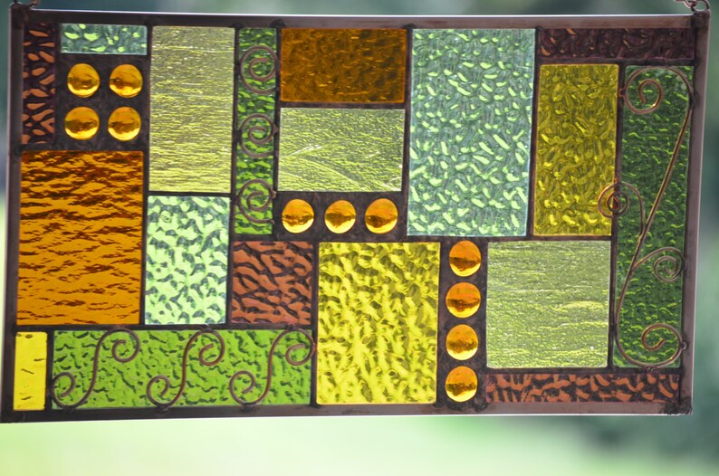 view of textures and colored glass nuggets in handmade stained glass panel