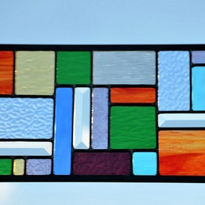 four seasons captured in colors of glass in leaded stained glass panel