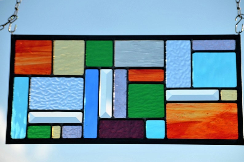 four seasons captured in colors of glass in leaded stained glass panel