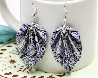 May include: A pair of blue and white patterned origami leaf earrings with silver hooks.