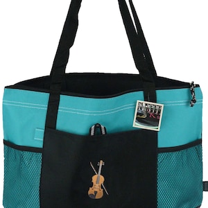 May include: A teal and black tote bag with black handles and a black bottom. The front pocket features an embroidered violin. The bag has mesh side pockets and a zipper closure. A tag is attached to the handle.