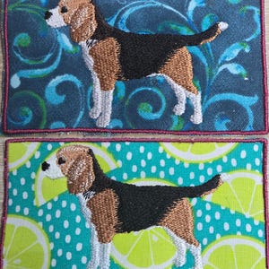 May include: Embroidered patches featuring a Beagle dog. One patch has a blue background with swirling patterns, the other has a turquoise background with lemon slices and white polka dots. Both patches have a pink border.