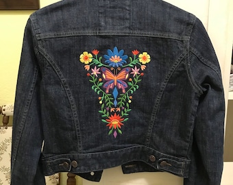 Denim jacket embroidered with Las Flores butterfly design