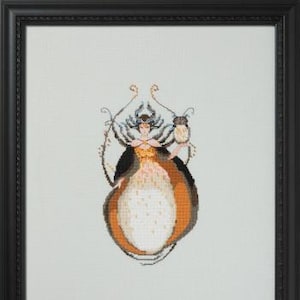 May include: Cross-stitch art of a woman in a flowing gown, holding an owl. The artwork features a black frame and a color palette of orange, black, white, and gold. The woman has a crown and the owl is perched on her hand. The style is reminiscent of Art Deco.