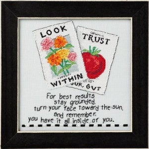 May include: A cross-stitch design with two seed packets, one with a flower and the text "LOOK WITHIN OUR GUT" and the other with a tomato and the text "ORGANIC TRUST". The text below the seed packets reads "For best results stay grounded. Turn your face toward the sun, and remember you have it all inside of you."