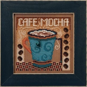 May include: A framed cross-stitch artwork featuring a teal coffee mug with a heart detail, filled with mocha. The words "CAFE MOCHA" are stitched above the mug. Brown coffee beans and a decorative border complete the design.