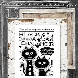 May include: A framed print featuring a whimsical design with two black cats and the words "Black Cat Chat Noir" in a playful font. The print includes French text and is set against a textured background.