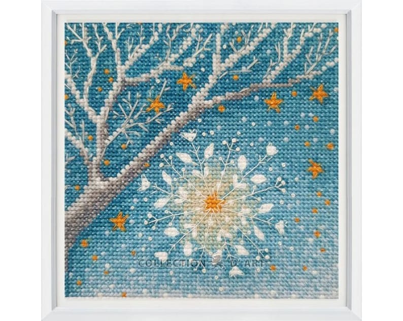 Pu&ograve; includere: Un ricamo a punto croce con un fiocco di neve bianco con un centro giallo, un ramo di albero bianco con foglie arancioni e uno sfondo blu con piccole stelle gialle.