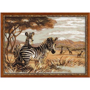 May include: A framed needlepoint artwork depicting a savanna scene. Two zebras are in the foreground, with giraffes, trees, and mountains in the background. The artwork is in shades of brown, tan, and beige.