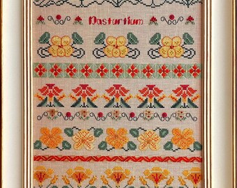 May include: Framed cross-stitch artwork featuring a floral design with orange and yellow flowers, green leaves, and the word "Nasturtium." The artwork is in a white frame with a beige background, showcasing detailed needlework.