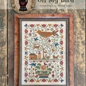 以下が含まれることがあります： テレサ・コグットによる「Oh My Bird」と題された額装済みのクロスステッチサンプラー。中央の木に大きな鳥、家、猫、犬、花柄が描かれています。デザインは、赤、青、ベージュの落ち着いた色調のハートと小さな花で縁取られています。