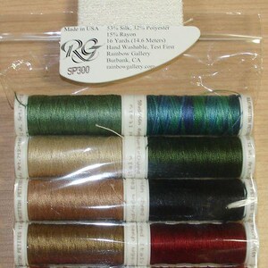 May include: A clear plastic package containing ten spools of thread in various colors including green, blue, gold, red, and brown. The packaging includes labels with text such as Petite Silk Lame Braid, 16 Yards, and Item 712-180 Glendon Place.