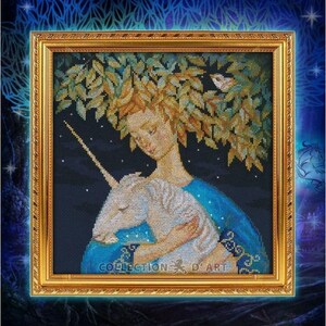 May include: Cross-stitch artwork in a gold frame depicts a woman with a leafy crown embracing a unicorn. The woman wears a blue gown, and the background is a dark blue night sky with stars. The artwork is labeled "COLLECTION D' ART".
