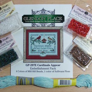 May include: A Glendon Place Cardinals Appear cross-stitch pattern sheet with four Mill Hill glass seed bead packets in white, red, dark green, and bronze, plus a skein of light blue Sullivans embroidery floss for needlework projects.