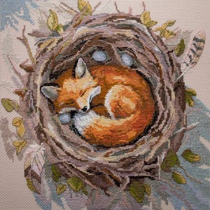 May include: A cross-stitch depiction of a sleeping fox curled up in a nest. The fox has orange fur with white accents, nestled among twigs, leaves, and three blue eggs. The nest is surrounded by leaves and a feather.