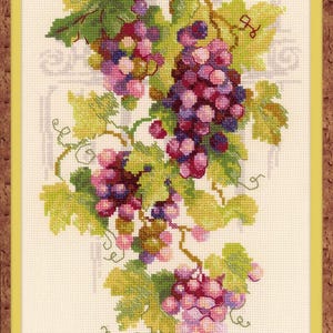 May include: Cross-stitch artwork of a cluster of grapes with green leaves and curling vines. The grapes are various shades of purple and pink. The artwork is framed in a yellow-brown frame.