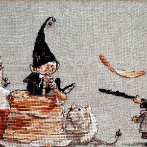 May include: A cross-stitch embroidery depicting a gnome with a pointed hat, holding a small object, sitting on a stack of brown fabric. A small white animal with a long snout is in the foreground. A second gnome with a brown dress and a white apron is holding a stick and looking to the left. The background is a light brown fabric.
