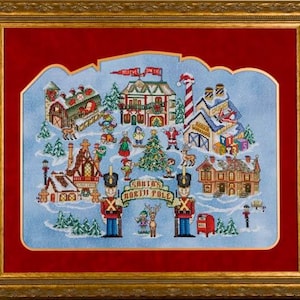 Puede incluir: Un diseño de punto de cruz colorido que representa una escena de pueblo de invierno con el taller de Santa Claus, un soldado de juguete y el texto "Santa's North Pole".
