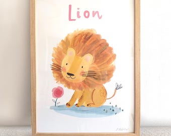 May include: A framed wall art print featuring a watercolor illustration of a yellow lion with a large orange mane, sitting next to a small pink flower on a blue patch of ground. The word Lion is printed in pink letters above the lion character.