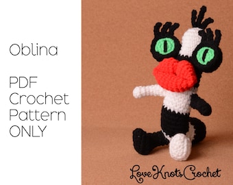 May include: A handmade crochet creature in black, white, and red, with green eyes and a large red mouth. The text "Oblina PDF Crochet Pattern ONLY" is on the left. The Love Knots Crochet logo is at the bottom.