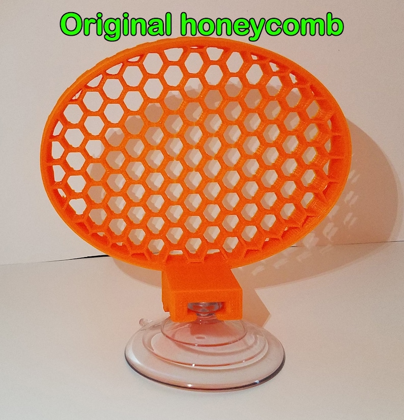 May include: Orange honeycomb-shaped suction cup holder with a clear suction cup base.